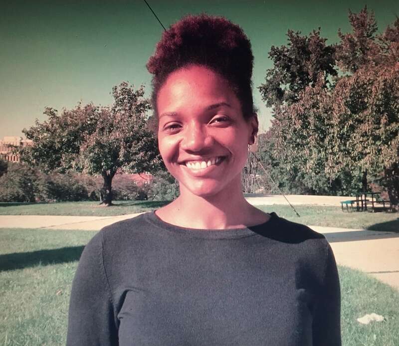 Dr. Lola Fatoyinbo headshot smiling with blue sky and grass background
