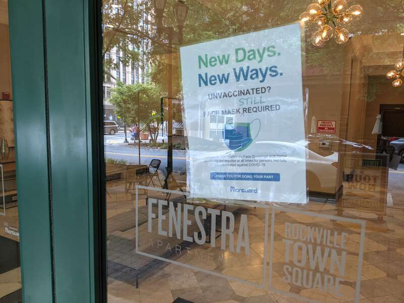 "New Days. New Ways. Unvaccinated? Face Mask Still Required" Fenestra Apartments, Rockville Town Square, Maryland.