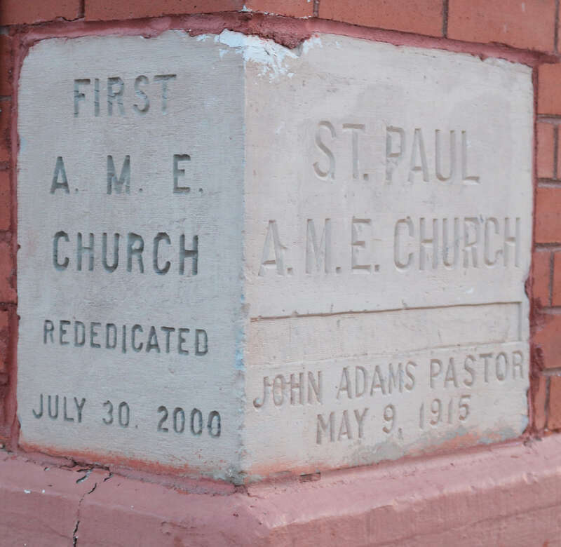 The cornerstone on the First African Methodist Episcopal Church building, located at 613 West Mesa Avenue in Pueblo, Colorado. The left side of the cornerstone says, "First A. M. E. Church / Rededicated / July 30, 2000." The right side says, "St.