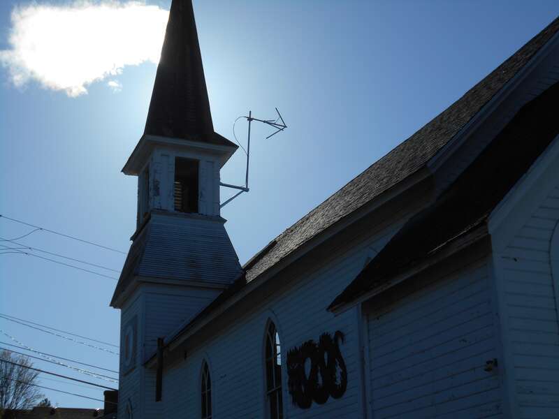 Antenna for Bellingham's new community radio station KVWV stuck out of the old steeple of a church building that used to be called "The Karate Church."  It was the home of a Karate Institute, but now there are plans to put the Alternative Library