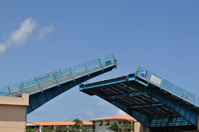 The J.D. Butler bascule bridge, carrying Florida State Road 810 over the Intercoastal Waterway, closing after allowing a vessel to pass through. Deerfield Beach, Florida.