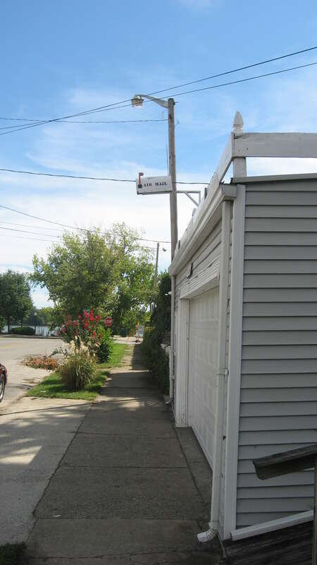 Sidewalk in front of a house on the western side of the 100 block of Pearl Street in Jeffersonville, Indiana, United States.  Note the "air mail" letterbox above the garage door.