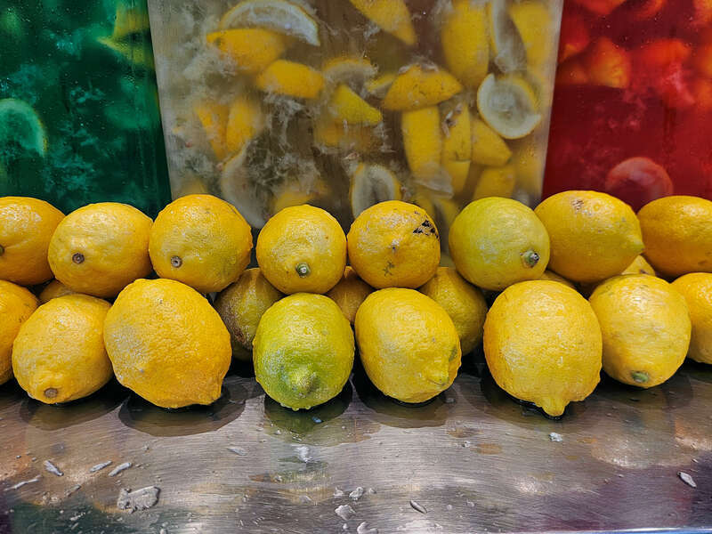 Containers of limeade (left), lemonade (middle), and strawberry lemonade (right).