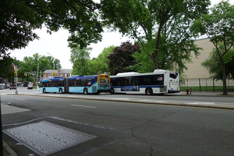 A northbound Q44 SBS bus (left) and a out-of-service Q20A bus in front of John Bowne High School at Main Street and Reeves Avenue in Queensboro Hill / Kew Gardens Hills, Flushing, Queens. Both these buses are "school tripper" buses serving the high