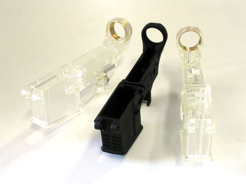 Two Tennessee Arms clear polycarbonate AR-15 lower receivers flank a traditional forged aluminum receiver.  I'm going to build a rimfire with one of them.