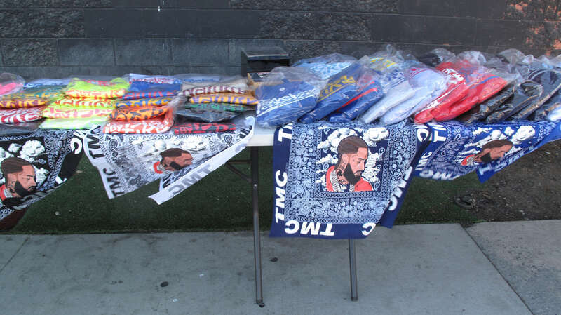 Fabrics with picture of Nipsey Hussle, for sale near his (closed) restaurant next to  the corner of Crenshaw and Slauson, Los Angeles