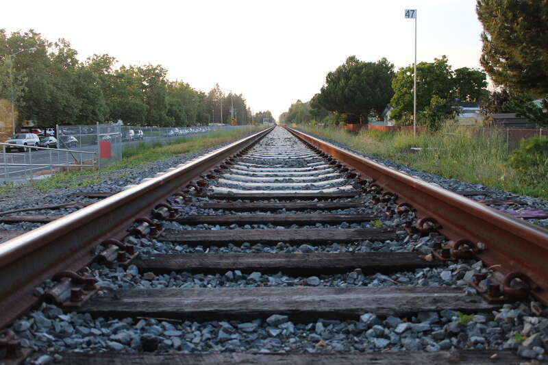 Northwestern Pacific Railroad rail tracks at Copeland Creek pedestrian crossing facing North parallel to Seed Farm Dr. in Rohnert Park, CA
