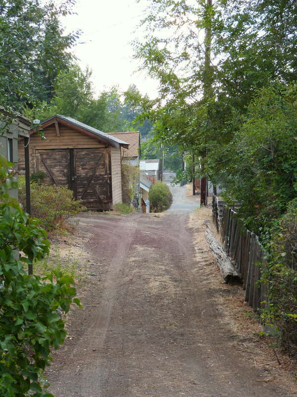 This alley in the Old Town Historic District in Bend, Oregon, United States, is seen from Northwest Lava Road, between Northwest Florida and Georgia Avenues. The historic district is listed on the US National Register of Historic Places.