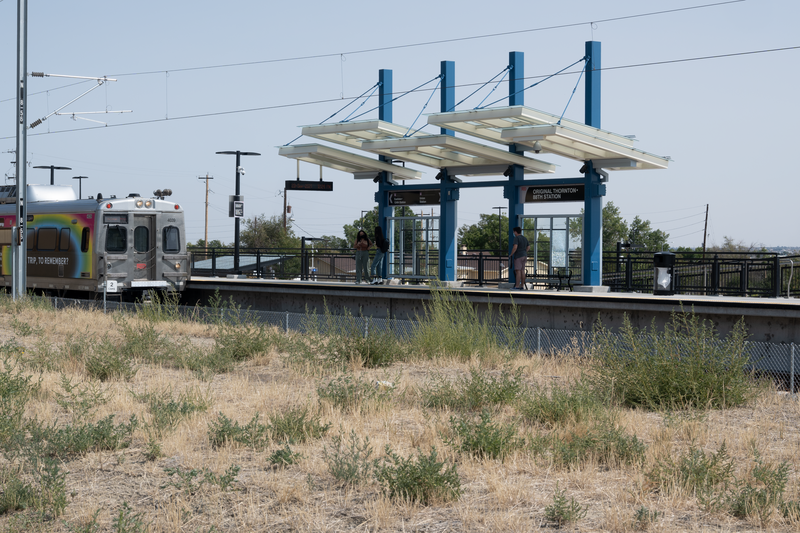Original Thornton &amp; 88th RTD station viewed from west. In foreground a southbound RTD commuter rail train is arriving.