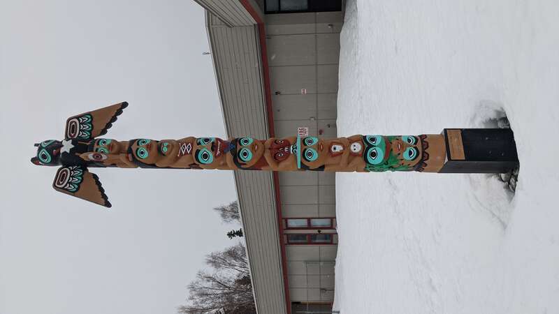 a modern totem pole in Anchorage, AK
