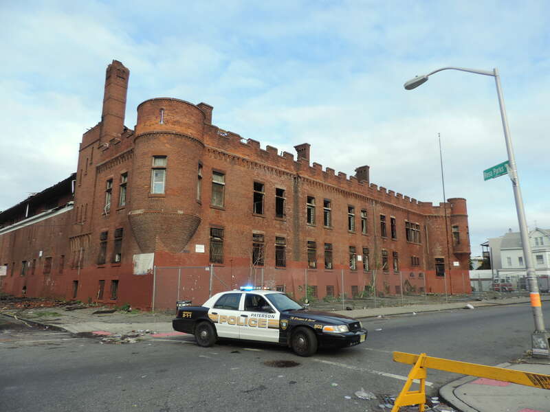 Looking northeast across closed Market St and Rosa Parks Blvd at armory and police car
