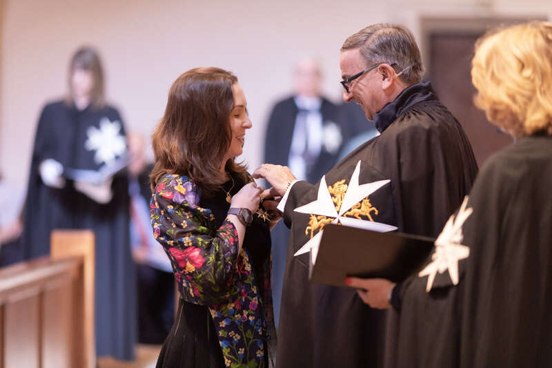 Princess Raiyah bint Al Hussein, a member of the royal family of Jordan, being invested as a Dame of Justice of the Most Venerable Order of the Hospital of Saint John of Jerusalem by Prior of the Priory in the USA, Nigel Heath, KStJ.