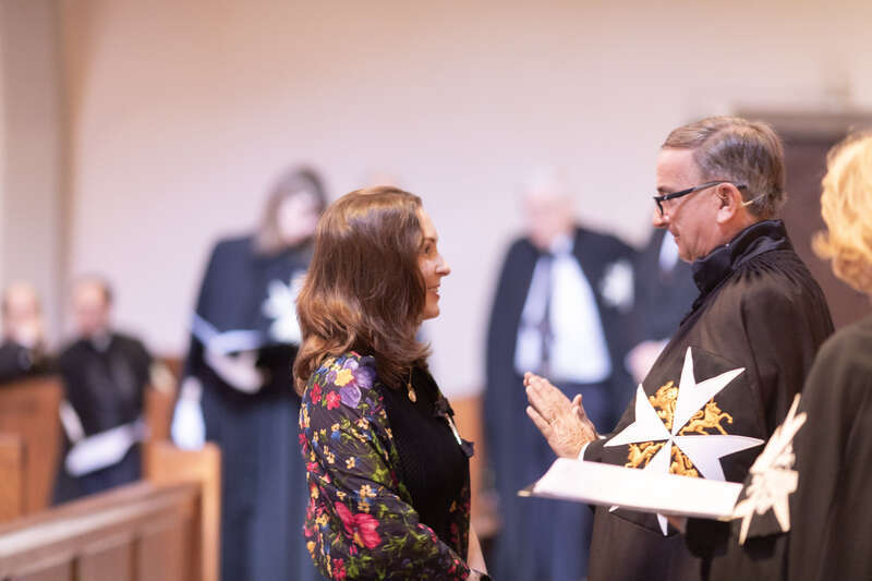 Princess Raiyah bint Al Hussein, a member of the royal family of Jordan, being invested as a Dame of Justice of the Most Venerable Order of the Hospital of Saint John of Jerusalem by Prior of the Priory in the USA, Nigel Heath, KStJ.