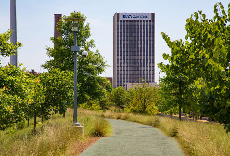A BBVA Tower skyscraper in downtown Birmingham, Alabama, as seen from a trail in Railroad Park, City of Birmingham, Ala.