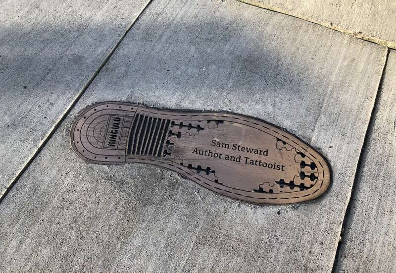 Bronze bootprint inlaid into the sidewalk in memory of Samuel Steward ("author and tattooist"), located in the San Francisco South of Market Leather History Alley.