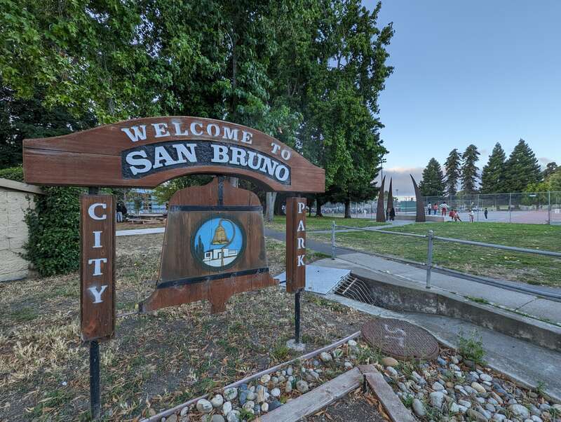Bell-shaped sign with city logo