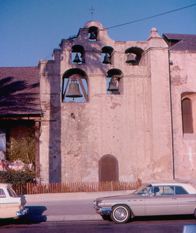Mission San Gabriel Arcangel was founded by Fra Junipero Serra in 1771.  This is the bell wall ("campanato").  A Buick is in the foreground, but I do not know the year.