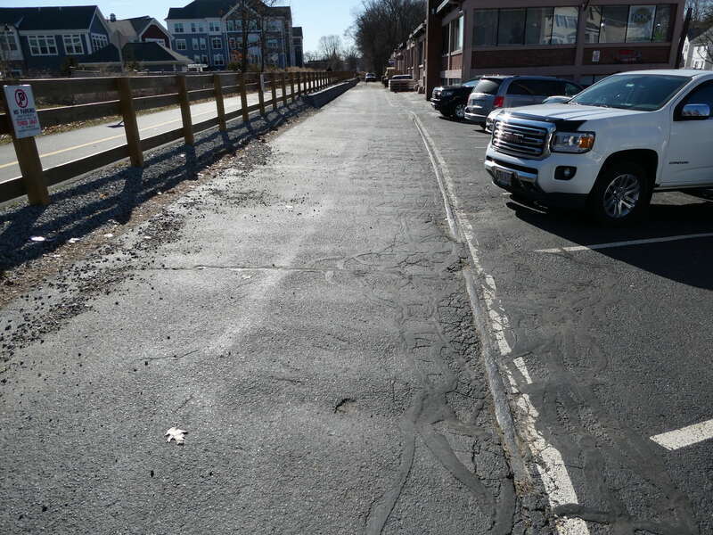 An old rail from the Saxonville Branch seen in a parking lot in March 2022