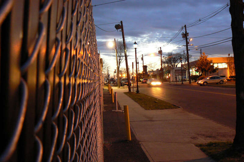 South Avenue; fence; evening; headlights