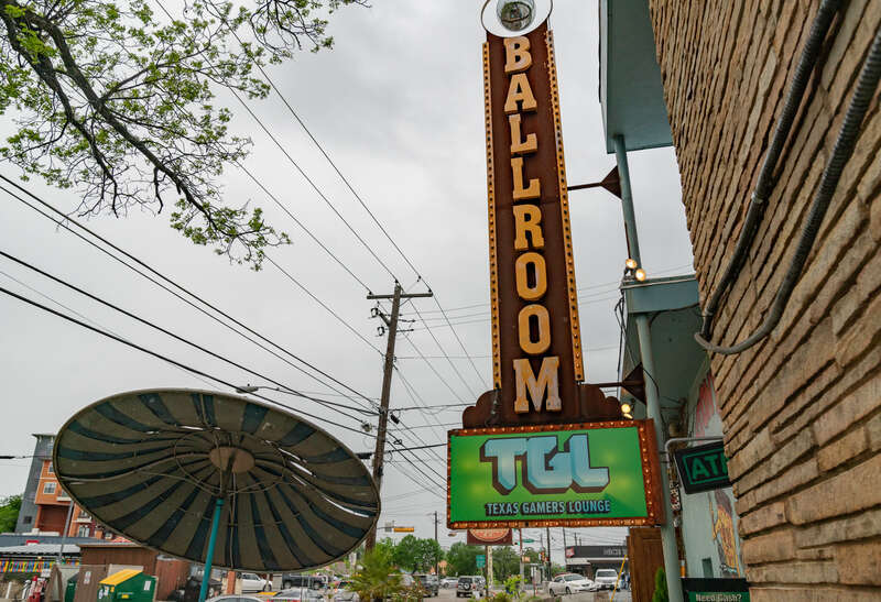 The Texas Gamers Lounge at 29th &amp; Fruth Street in Austin, Texas. TGL is an arcade near the University of Texas at Austin (UT Austin) campus. Outside the building is a "ballroom" sign and a patio seating area.