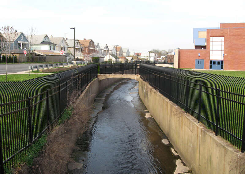 Channelized Weasel Brook flows northeast from Central Avenue bridge in Passaic, NJ towards w:Passaic River.
