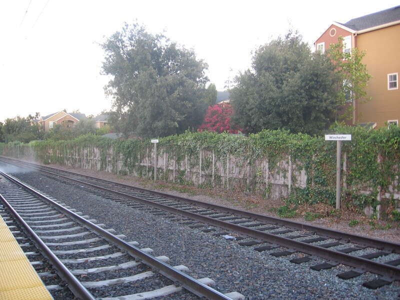 The Winchester Transit Center in Campbell, California, USA.  Freight line track is visible past the light rail line.