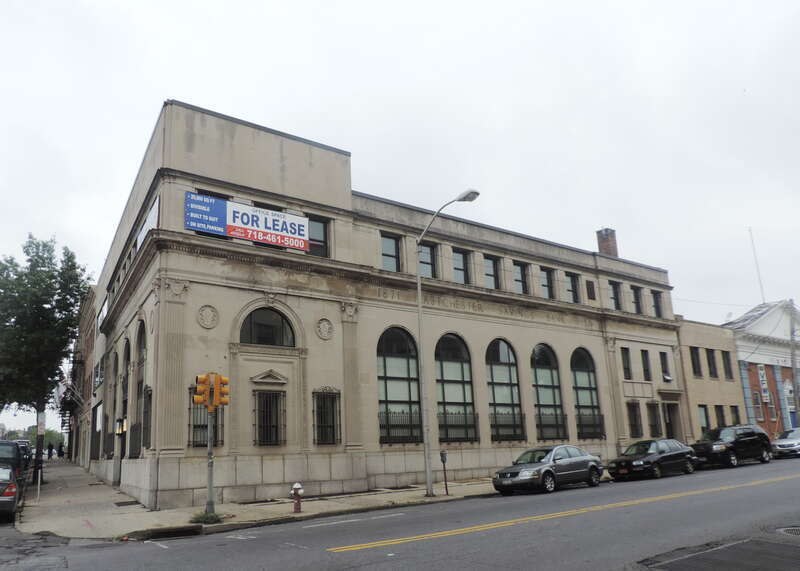 Looking southwest at former bank on a cloudy midday.
