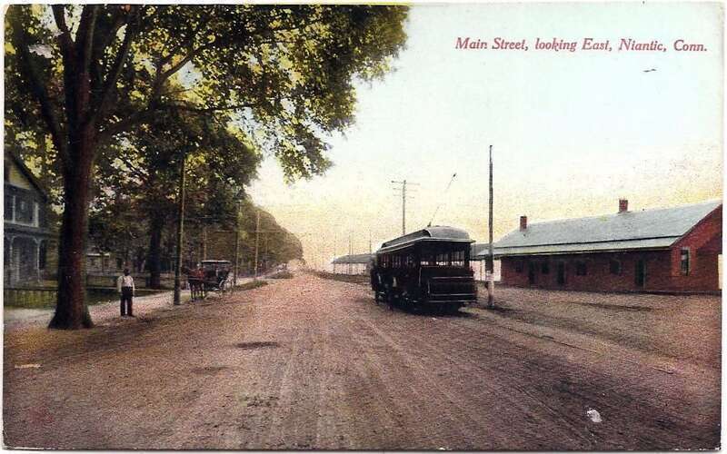 1911-ostmarked postcard of Main Street in Niantic, Connecticut, facing east. A New London &amp; East Lyme Street Railway trolley is on the street; the New Haven Railroad's Niantic station is at right.