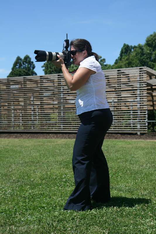 Photographer takes a picture at a wedding held at the J. C. Raulston Arboretum in Raleigh, North Carolina.