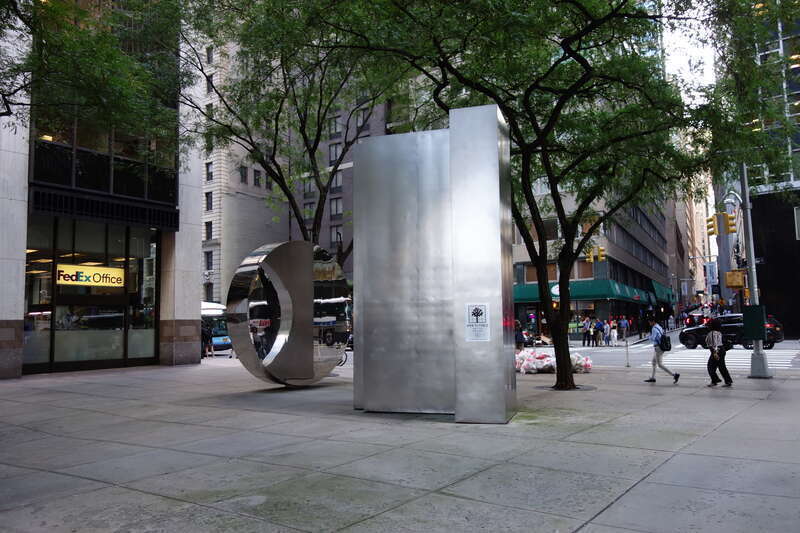 The steel circle sculpture by Yu Yu Yang at the north/west end of 88 Pine Street Plaza, between Wall Street Plaza (88 Pine Street) and 100 Wall Street at Water Street and Pine Street in the Wall Street area of the Financial District, Manhattan.