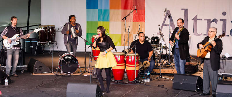 Richmond Folk Festival 2015
Andre Veloz (center) is a singer from the Dominican Republic based in New York City.  Her musical specialty is "bachata," a style originating in the Dominican Republic and first recorded in the 1960s. Historically