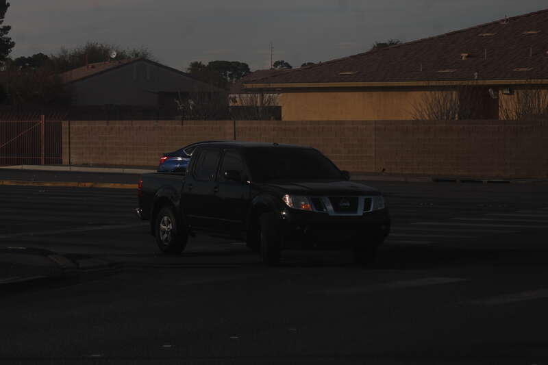 A Black Nissan Frontier D40 turning onto Simmons Street from Craig Road in North Las Vegas, Nevada.