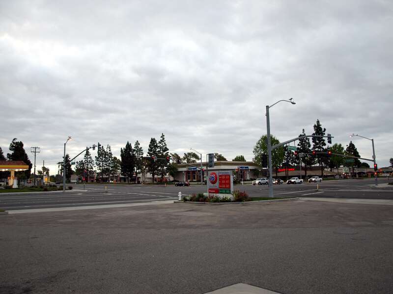 The signalized street intersection of Brookhurst Street and Talbert Avenue in Fountain Valley, California as seen from the parking lot of 76 gas station at 17971 Brookhurst Street, view looking southeast.This photograph was taken with an Olympus