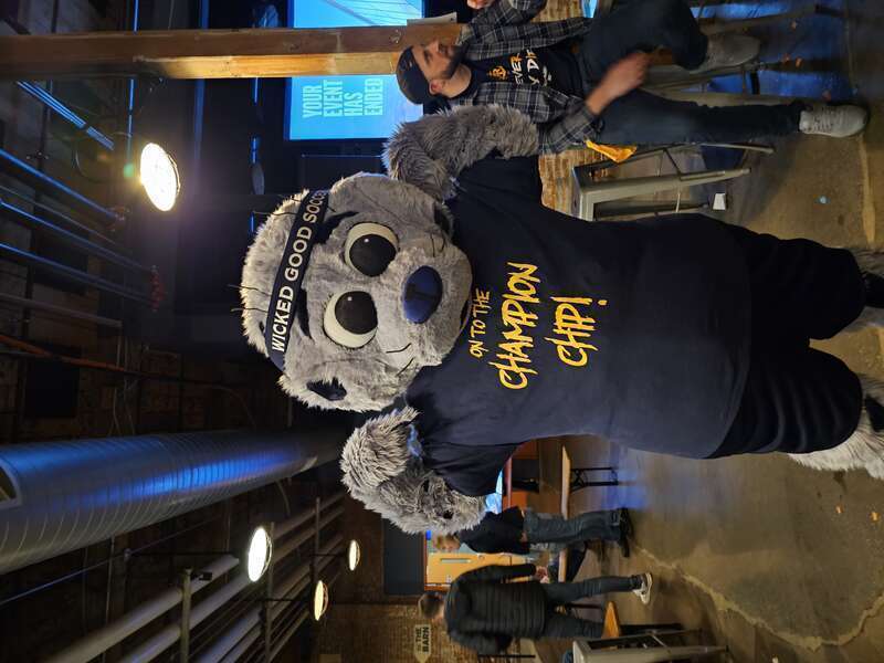 Rhode Island FC mascot Chip wearing a shirt saying "On to the Champion Chip"