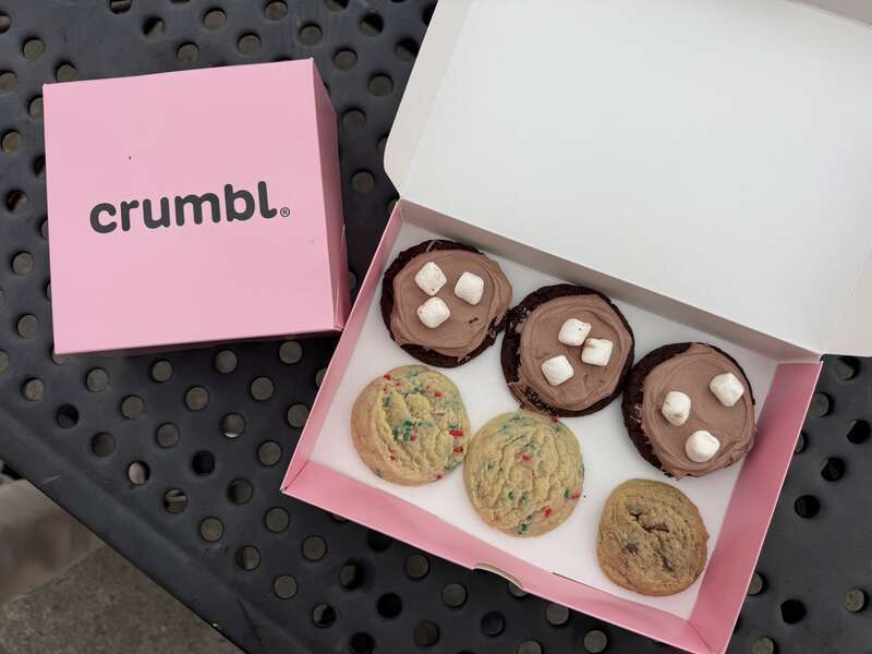 Three types of cookies from Crumbl Cookies in Petaluma, California: Frozen hot chocolate (chocolate cookie with hot cocoa-flavored mousse and mini marshmallows), holiday confetti (warm vanilla sugar cookie with red and green sprinkles) and chocolate