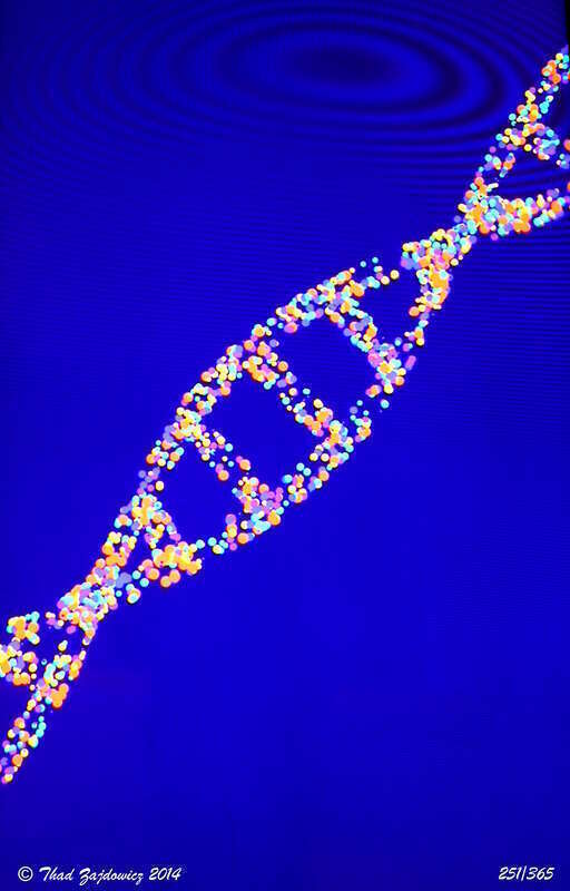 Walking to work, my eye was caught by a bright blue rectangle at the entrance to the parking garage in Rockville Town Center. Turned out to be an ad with dots forming the double helix of DNA. When I looked at the shot, saw the Moire effect you see in
