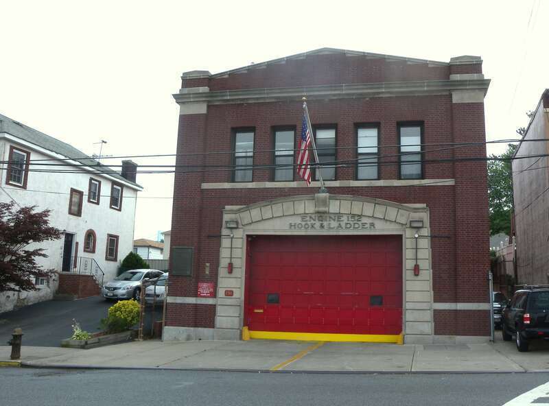 Looking south across Hylan Boulevard from Tompkins Avenue at Engine firehouse on a cloudy midday.