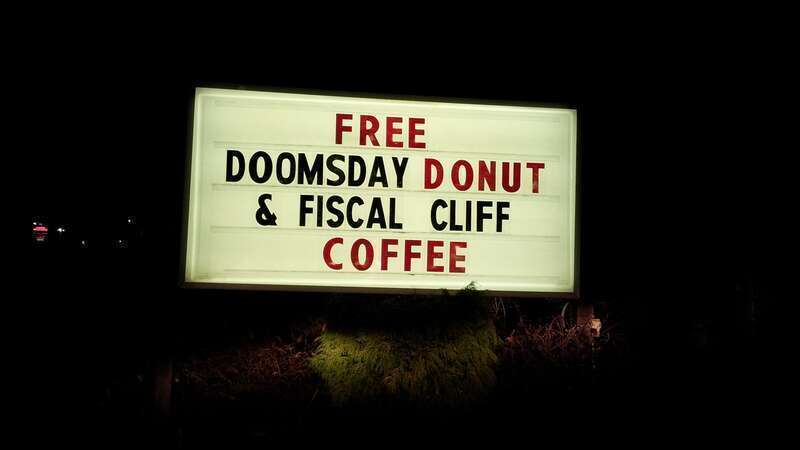 Sign advertising "FREE DOOMSDAY DONUT &amp; FISCAL CLIFF COFFEE" at Petersen's Carpet and Flooring in Frederick, Maryland.

Ben Schumin is a professional photographer who captures the intricacies of daily life.  This image may be used under Creative