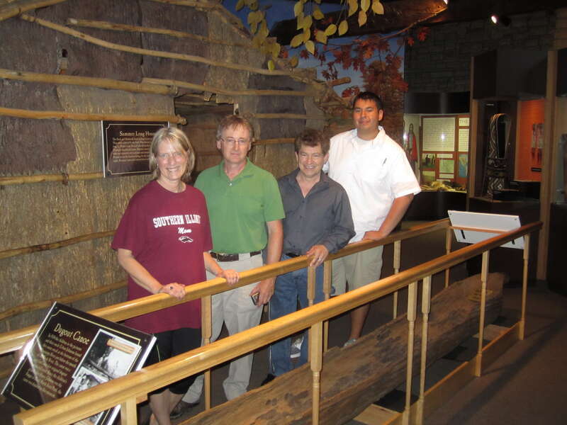 The service staff and Beth Carvey,Director of Hauberg Indian Musuem are standing above a traditional canoe at the Hauberg Indian Museum in Rock Island, Illinos. Service photo.