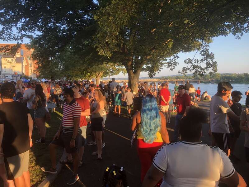 People walking and waiting in line for food trucks on Riverfront Park in Harrisburg, PA, for "July 4th Food Trucks &amp; Fireworks" in 2021