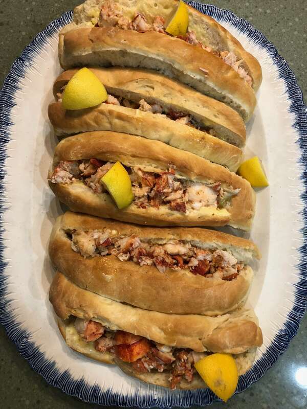 True New England classic of homemade lobster rolls. Rolls of white flour and egg based dough, picked lobster meat and homemade mayonnaise.