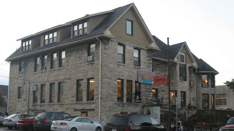 Eastern side and rear of the Kirkwood Manor (now the Soma and Laughing Planet), a coffeehouse/restaurant located at 322 E. Kirkwood Avenue in Bloomington, Indiana, United States.  Built in 1895 according to a design by John L. Nichols and remodeled