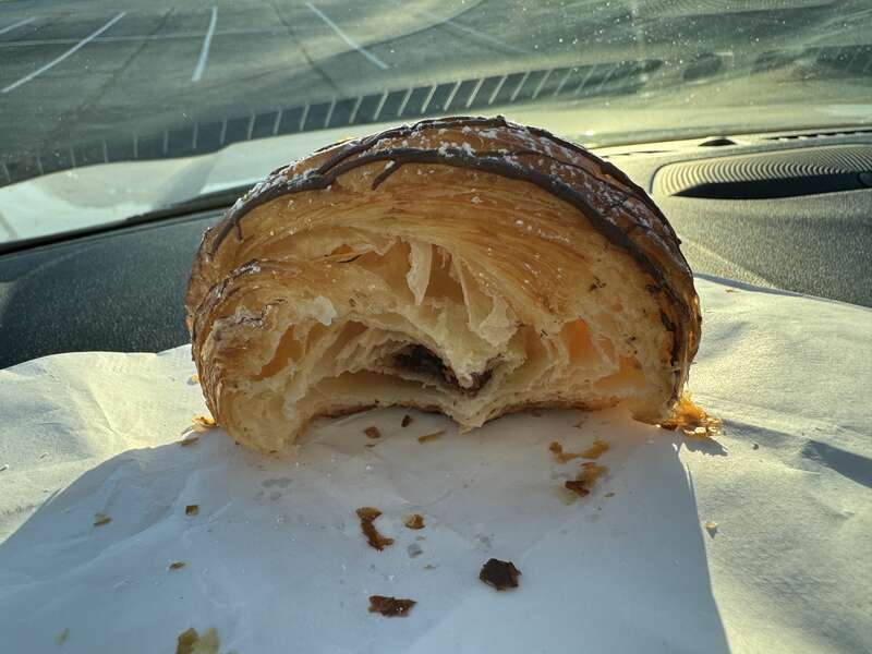 A half eaten chocolate croissant from Le Croissant French Bakery, Greenwood, Indiana.