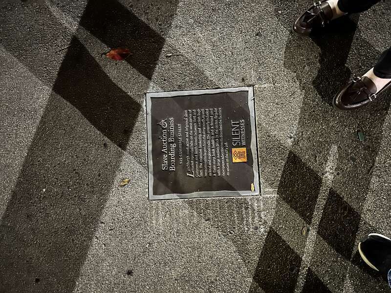 A marker from the Silent Witnesses project, commemorating the location of a prominent slave market in town. The plaque reads as follows: Slave Auction &amp; Boarding Business 925 Commerce Street Lynchburg’s most active and infamous slave market
