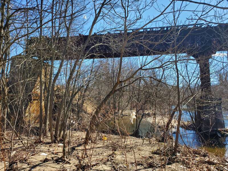 The partially-destroyed Meriden, Waterbury and Connecticut River Railroad bridge over the Naugatuck River, seen in March 2023
