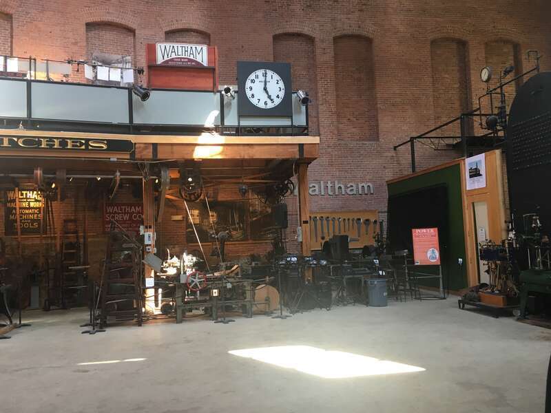 Machine shop at w:Charles River Museum of Industry &amp; Innovation, with overhead belt drives. Watch making exhibit is on upper level.