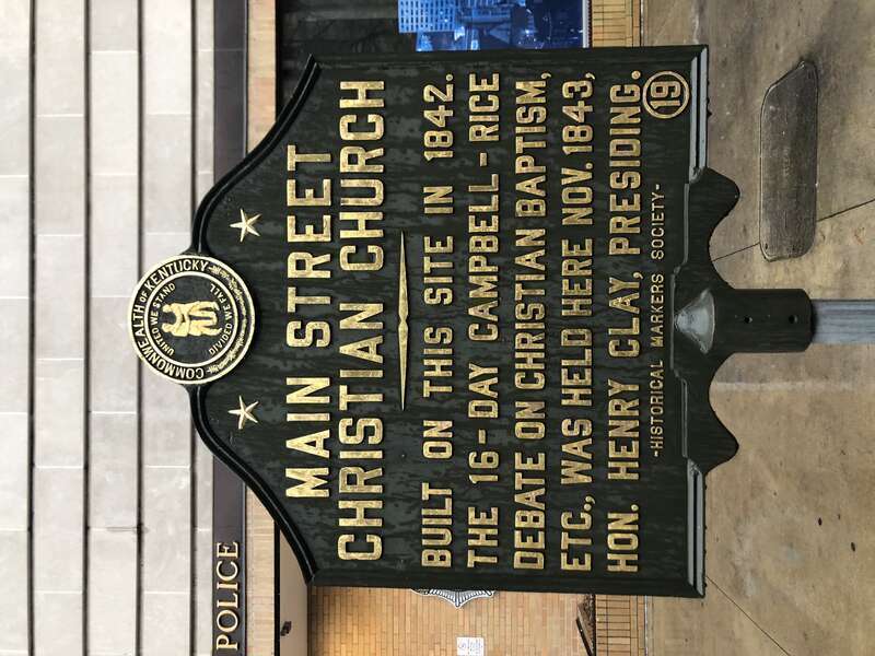 Historical Marker number 19 commemorates the site of the Main Street Christian Church. Built in 1842 it was the site of the Campbell-Rice Debates on Christian Baptism presided over by Henry Clay. The building was razed in 1903.