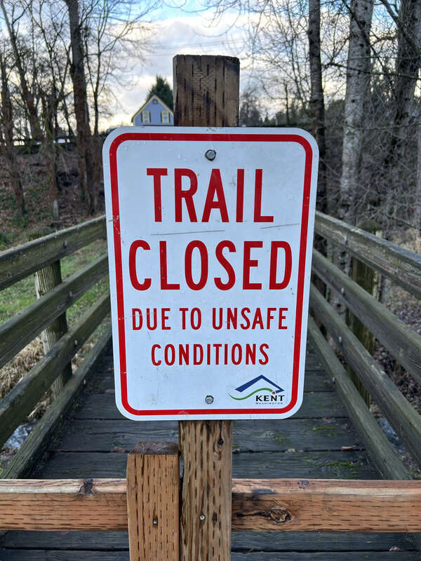 Trail closed sign at the Mill Creek Canyon Earthworks, a public park in Kent, Washington.