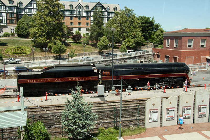 Shot from a pedestrian crossover, N&amp;W 611 sits in front of the Hotel Roanoke (in the background) and the former N&amp;W passenger station (on the right) on National Train Day 2010.