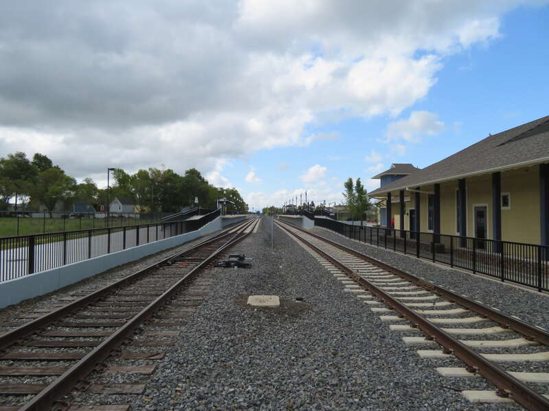 North end of Cotati station in April 2018, with the station building, platforms, and gauntlet tracks visible